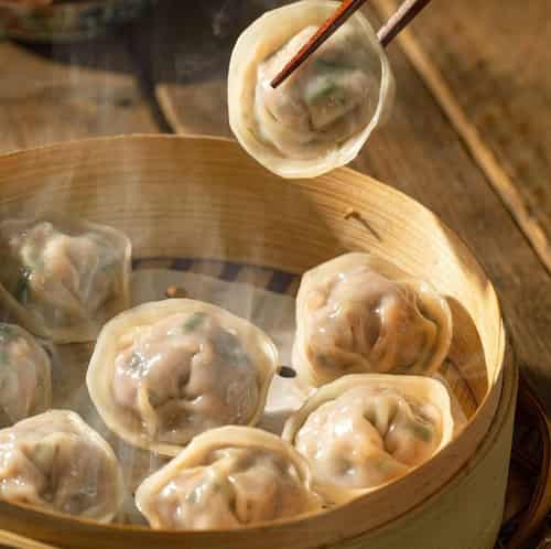 The steaming dumplings are in the steamer.